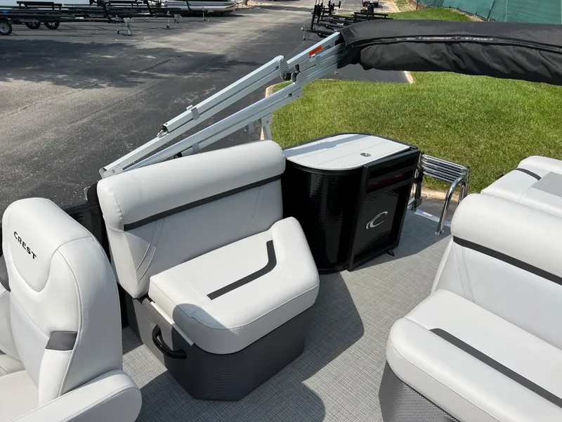 Slide: The Image of 2024 Crest Classic LX 220 pontoon boat interior with plush seating and modern design. - 9