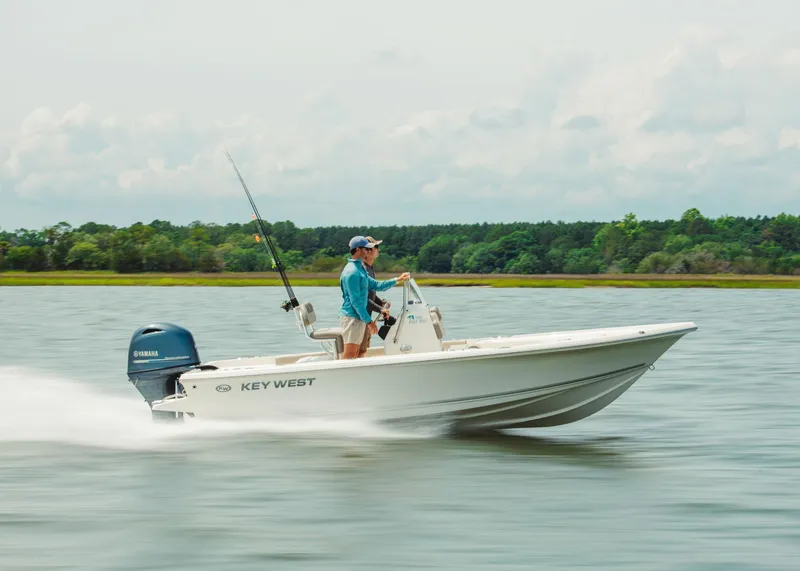 Slide: The Image of 2024 Key West 188 Bay Reef boat cruising on a lake. - 14