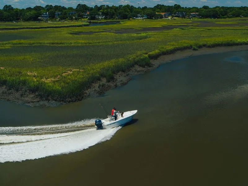 Slide: The Image of 2024 Key West 188 Bay Reef boat cruising through coastal waters. - 15