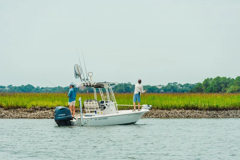 Slide: The Image of 2024 Key West 188 Bay Reef boat with two people fishing in a scenic waterway. - 18