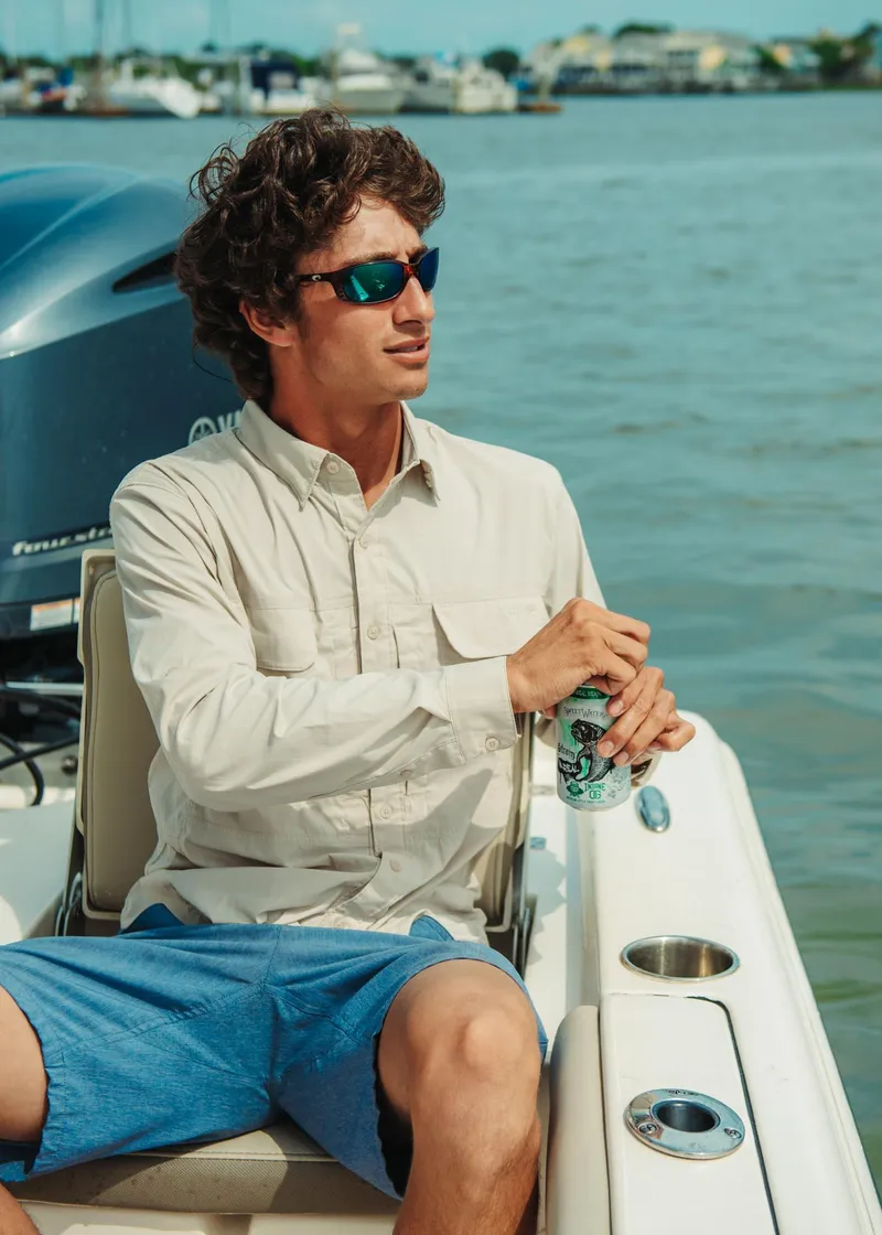 Slide: The Image of Man relaxing on a 2024 Key West 188 Bay Reef boat. - 26