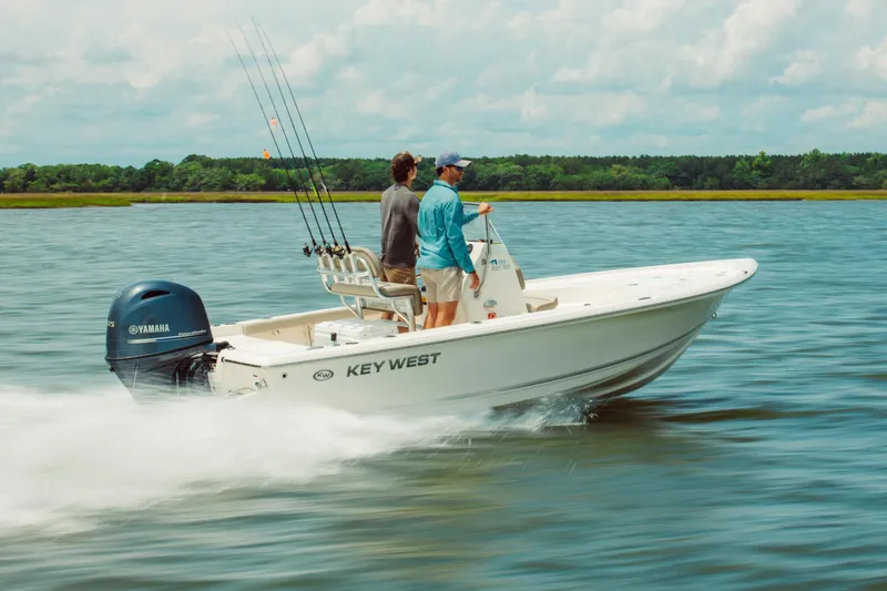 Slide: The Image of 2024 Key West 188 Bay Reef boat cruising on a lake with two people onboard. - 29