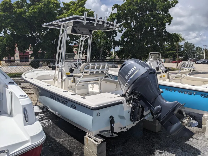 Slide: The Image of 2024 Key West 188 Bay Reef boat with Yamaha outboard motor, docked on blocks. - 3