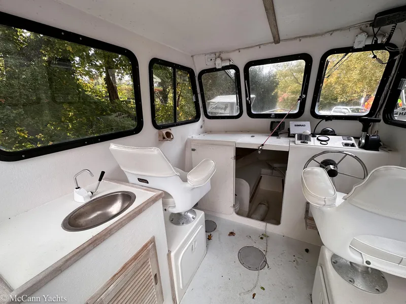 Slide: The Image of Interior of 2002 Eastern Lobsterman 22 boat with steering wheel, seats, and sink. - 10