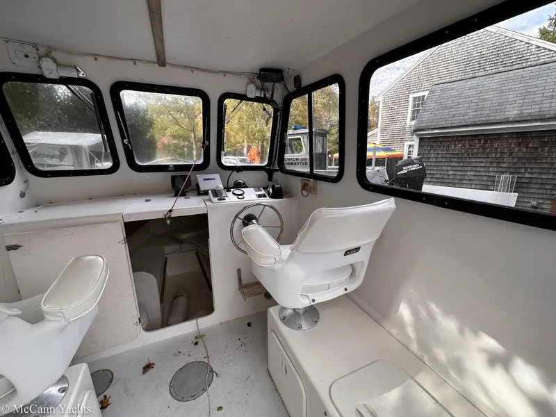 Slide: The Image of Interior of a 2002 Eastern Lobsterman 22 boat with steering wheel and seating. - 11