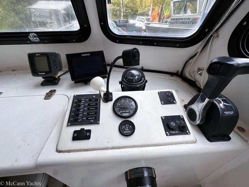 Slide: The Image of Control panel of a 2002 Eastern Lobsterman 22 boat with navigation instruments. - 13