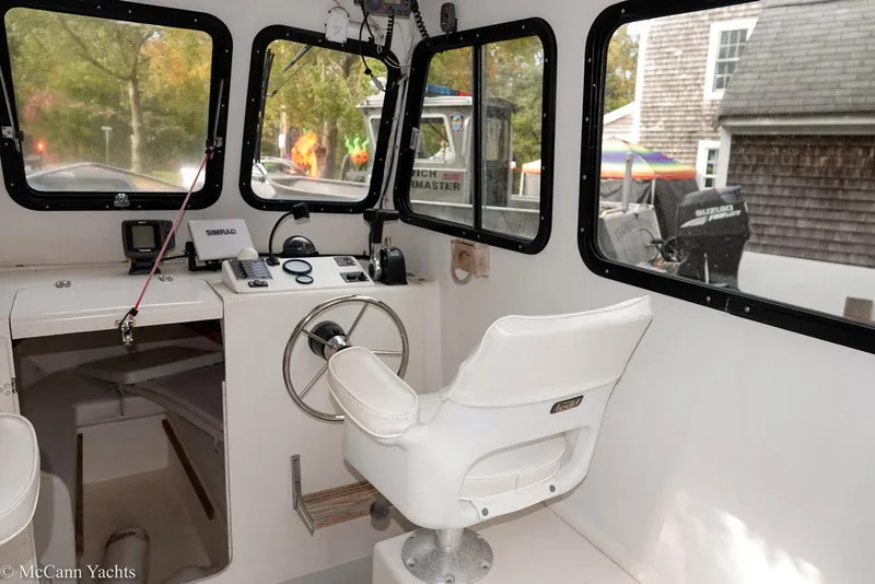 Slide: The Image of Interior of a 2002 Eastern Lobsterman 22 boat with steering wheel and captain's chair. - 25