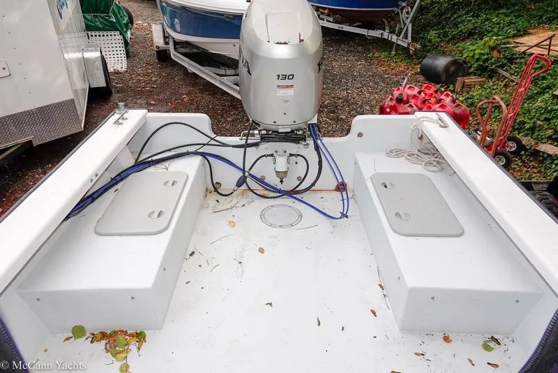 Slide: The Image of 2002 Eastern Lobsterman 22 boat deck with outboard motor and storage compartments. - 31