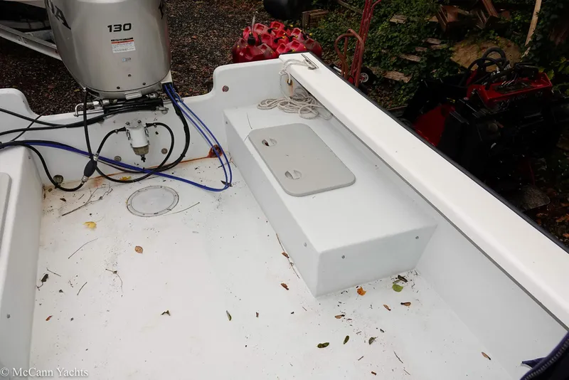 Slide: The Image of 2002 Eastern Lobsterman 22 boat interior with outboard motor and storage compartment. - 33