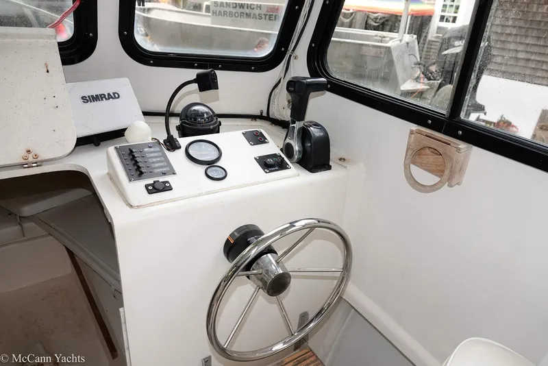 Slide: The Image of 2002 Eastern Lobsterman 22 boat cockpit with steering wheel and control panel. - 34