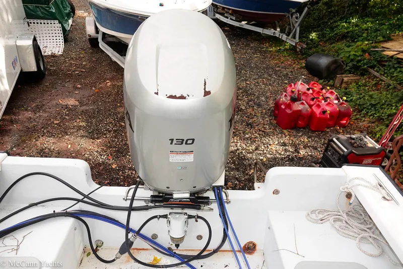 Slide: The Image of Outboard motor on 2002 Eastern Lobsterman 22 boat, surrounded by equipment and fuel containers. - 40