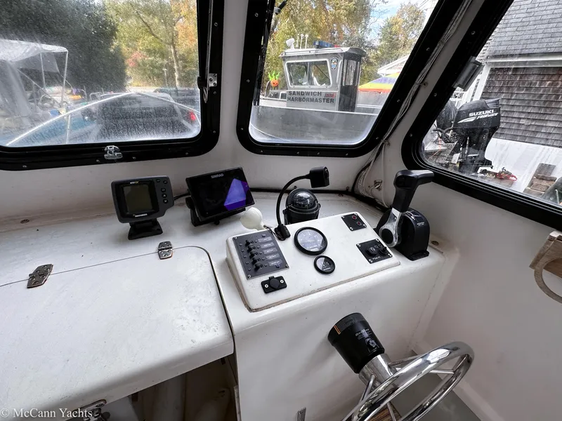 Slide: The Image of 2002 Eastern Lobsterman 22 boat cockpit with navigation instruments and steering wheel. - 12