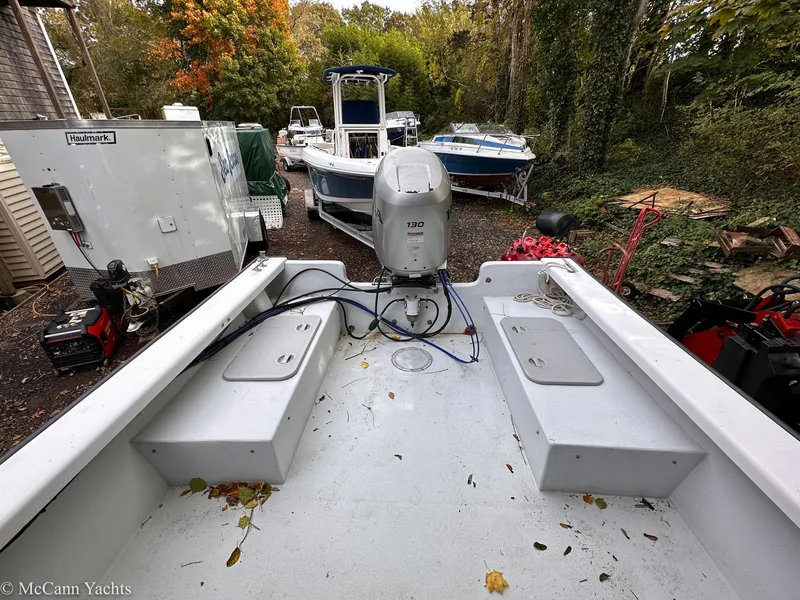 Slide: The Image of 2002 Eastern Lobsterman 22 boat with outboard motor, surrounded by trees and other boats. - 14