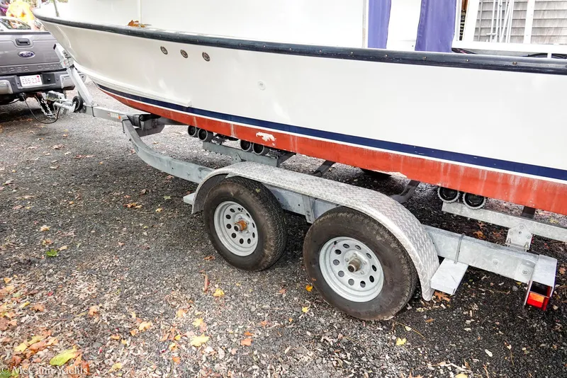 Slide: The Image of Trailer with 2002 Eastern Lobsterman 22 boat on gravel surface. - 22