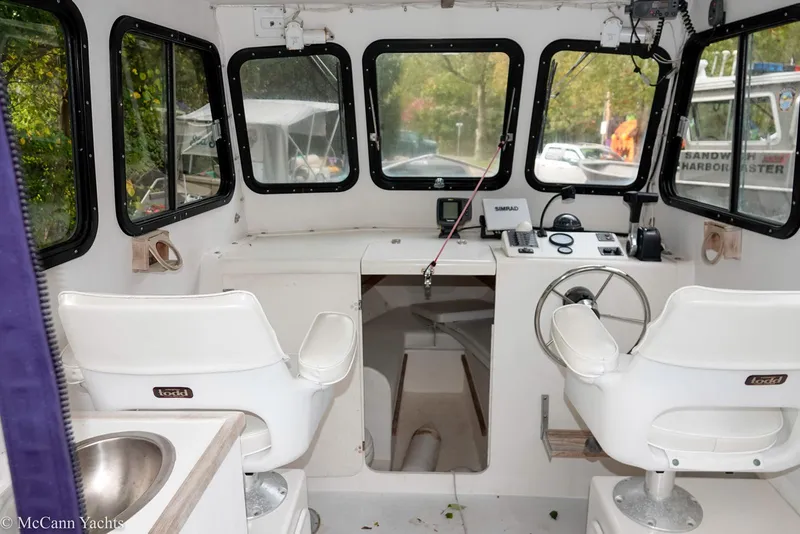 Slide: The Image of Interior of a 2002 Eastern Lobsterman 22 boat with steering wheel and seating. - 23