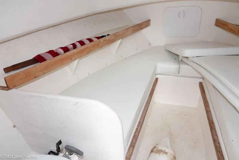 Slide: The Image of Interior of 2002 Eastern Lobsterman 22 boat with white seating and wooden accents. - 27