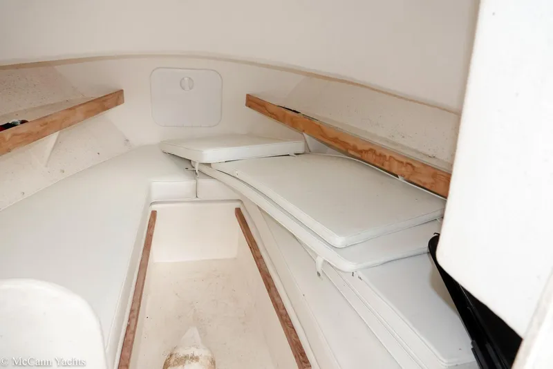 Slide: The Image of 2002 Eastern Lobsterman 22 cabin interior with white cushions and wooden accents. - 28