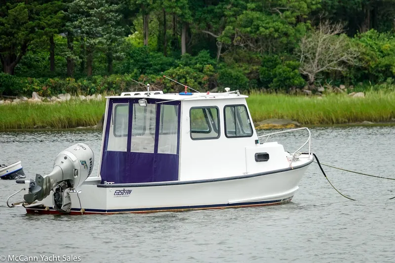 Slide: The Image of 2002 Eastern Lobsterman 22 boat anchored on a calm river with lush greenery. - 3