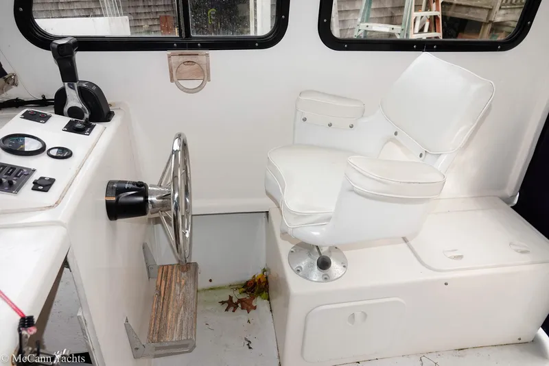 Slide: The Image of Interior of 2002 Eastern Lobsterman 22 boat with steering wheel and white captain's chair. - 30