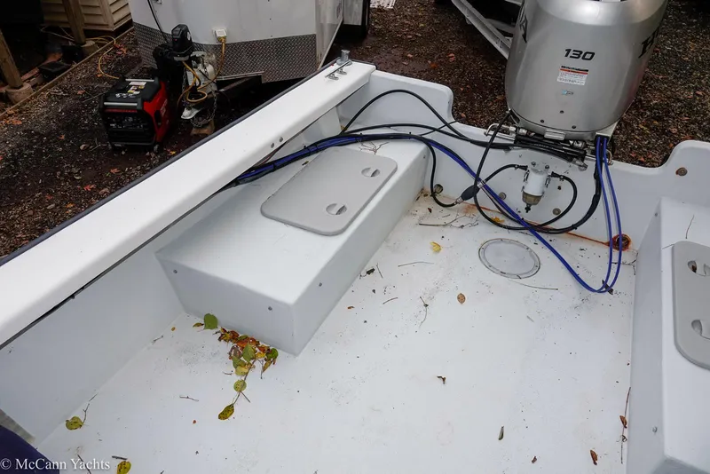 Slide: The Image of 2002 Eastern Lobsterman 22 boat deck with outboard motor and scattered leaves. - 32