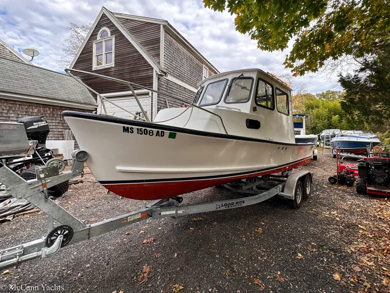 Slide: The Image of 2002 Eastern Lobsterman 22 boat on trailer, parked near a house with trees. - 7