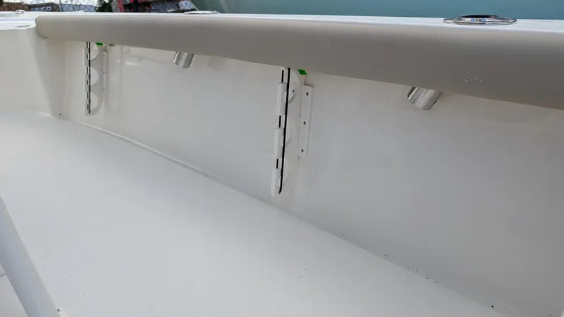 Slide: The Image of 2024 Key West 230 Bay Reef boat interior detail with rod holders. - 10