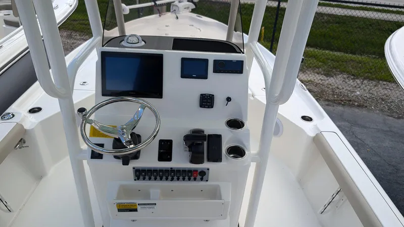 Slide: The Image of 2024 Key West 230 Bay Reef boat console with steering wheel and electronic displays. - 12