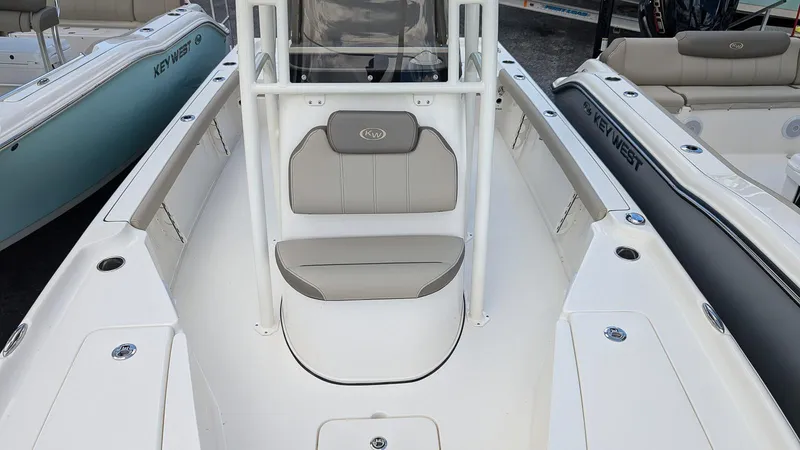 Slide: The Image of 2024 Key West 230 Bay Reef boat interior with seating and storage compartments. - 13