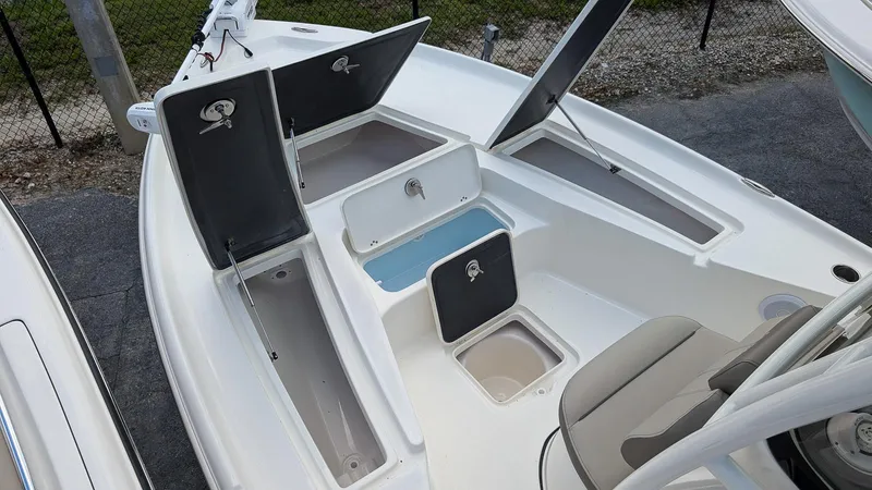 Slide: The Image of 2024 Key West 230 Bay Reef boat with open storage compartments. - 14