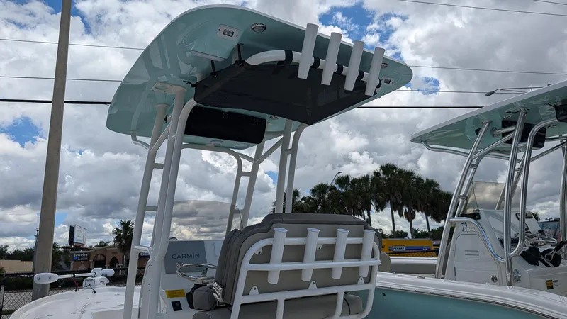 Slide: The Image of 2024 Key West 230 Bay Reef boat with T-top and rod holders. - 17