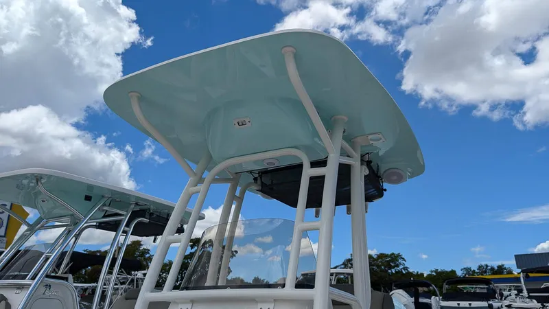 Slide: The Image of 2024 Key West 230 Bay Reef boat with T-top under blue sky. - 18