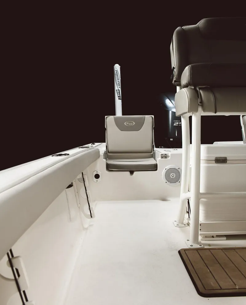 Slide: The Image of 2024 Key West 230 Bay Reef boat interior with seating and storage. - 28