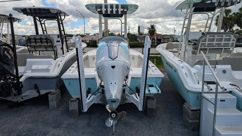 Slide: The Image of 2024 Key West 230 Bay Reef boat displayed at a dealership. - 3