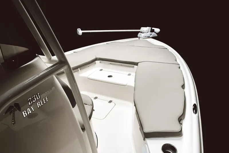 Slide: The Image of 2024 Key West 230 Bay Reef boat interior with cushioned seating and storage compartments. - 30