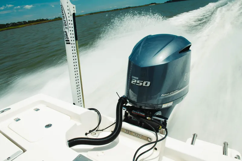 Slide: The Image of 2024 Key West 230 Bay Reef boat with Yamaha 250 engine cruising on water. - 34