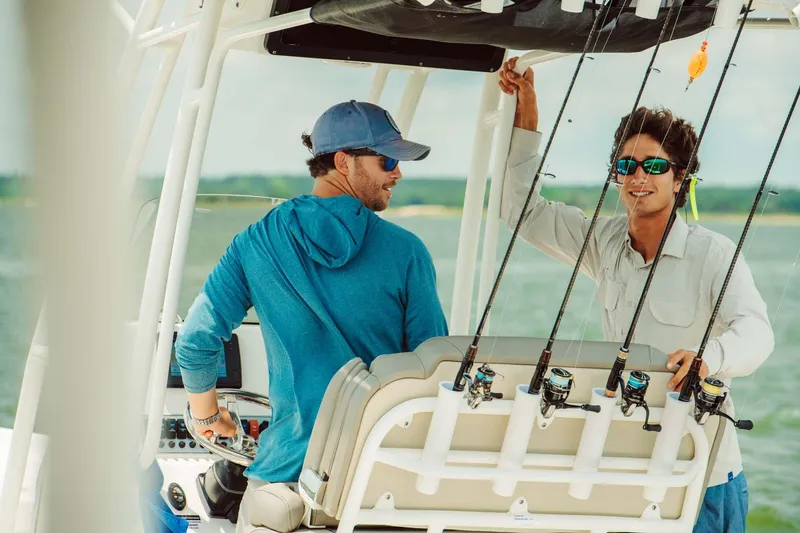 Slide: The Image of Two men on a 2024 Key West 230 Bay Reef boat, enjoying a fishing trip. - 35
