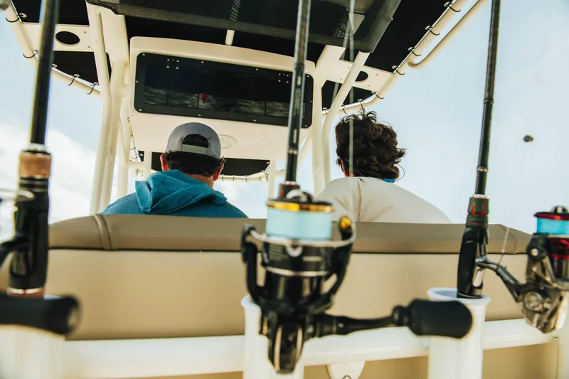 Slide: The Image of Two people on a 2024 Key West 230 Bay Reef boat with fishing rods. - 38