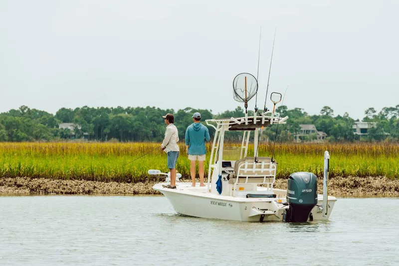 Slide: The Image of 2024 Key West 230 Bay Reef boat with two people fishing in a scenic marsh. - 42