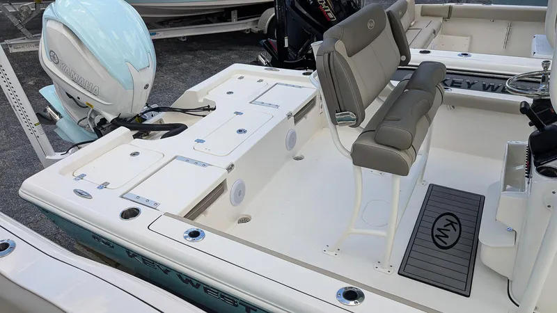 Slide: The Image of 2024 Key West 230 Bay Reef boat interior with seating and engine. - 6