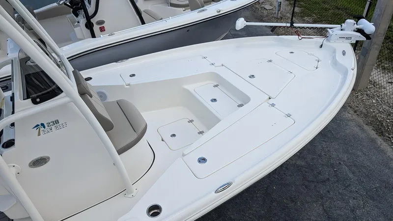 Slide: The Image of 2024 Key West 230 Bay Reef boat deck with storage compartments and seating. - 7