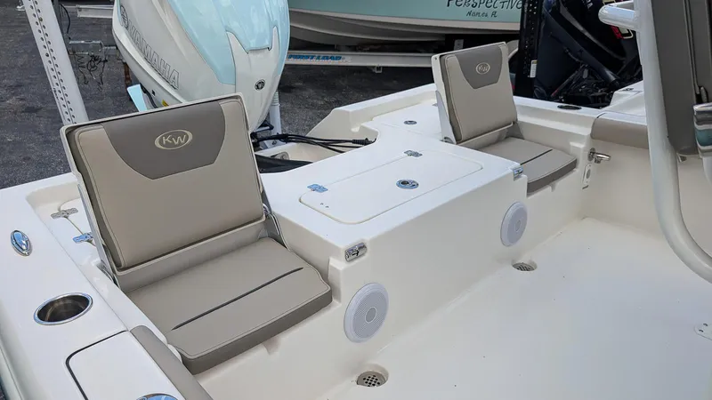 Slide: The Image of 2024 Key West 230 Bay Reef boat with cushioned seating and storage compartments. - 8