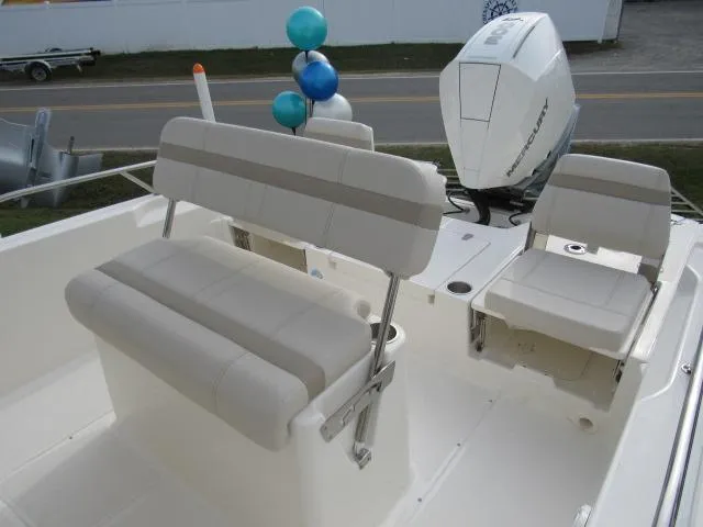 Slide: The Image of 2024 Boston Whaler 250 Dauntless boat interior with seating and Mercury outboard engine. - 12