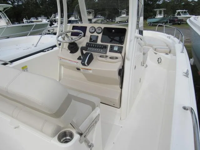 Slide: The Image of 2024 Boston Whaler 250 Dauntless boat interior with helm station and seating. - 13