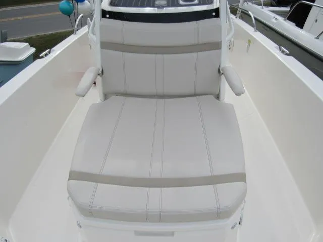 Slide: The Image of 2024 Boston Whaler 250 Dauntless boat seating area with cushioned bench. - 17