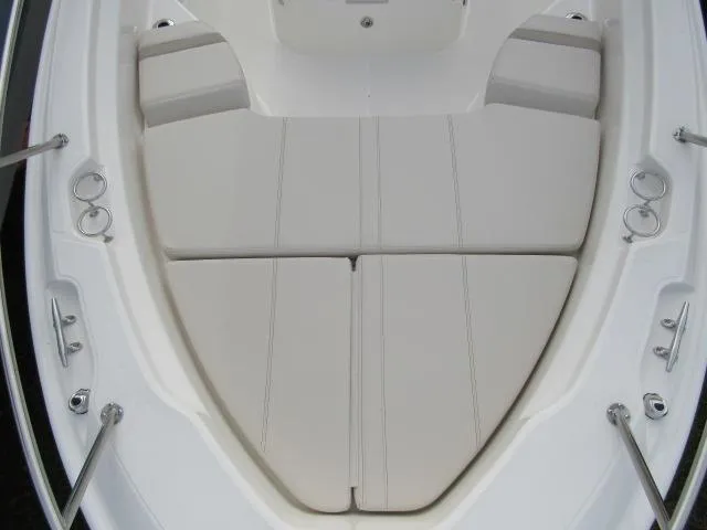 Slide: The Image of 2024 Boston Whaler 250 Dauntless bow seating area with white cushioned seats. - 18