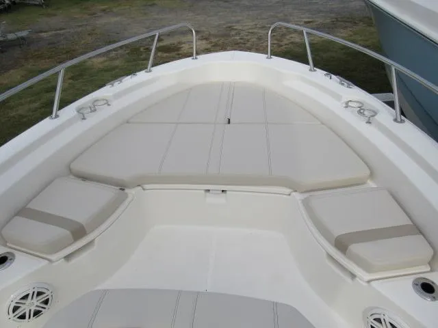 Slide: The Image of 2024 Boston Whaler 250 Dauntless boat bow seating area with cushioned seats and stainless steel railings. - 20