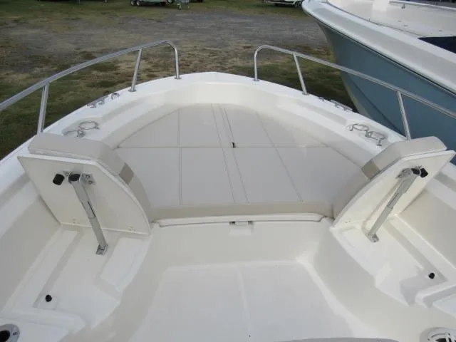 Slide: The Image of 2024 Boston Whaler 250 Dauntless boat bow seating area with cushioned seats. - 21