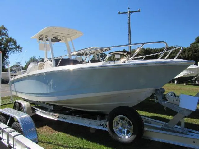 Slide: The Image of 2024 Boston Whaler 250 Dauntless boat on a trailer in a grassy area. - 28