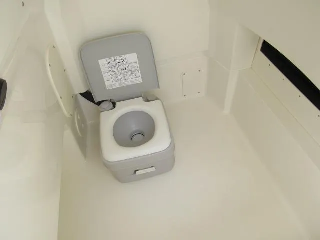 Slide: The Image of 2024 Boston Whaler 250 Dauntless boat interior with portable toilet. - 6