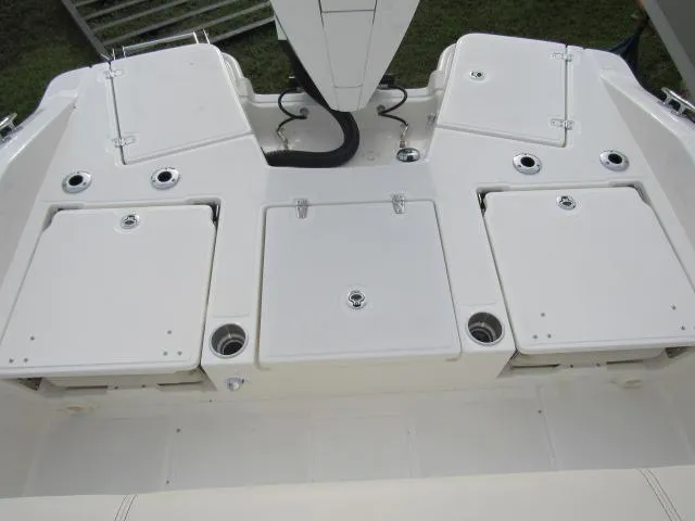 Slide: The Image of 2024 Boston Whaler 250 Dauntless boat deck with storage compartments and rod holders. - 9
